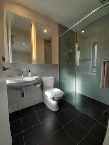 a bathroom with a toilet and a sink and a shower at MHYL Cosy Townhouse in Richmond 1 parking in Melbourne