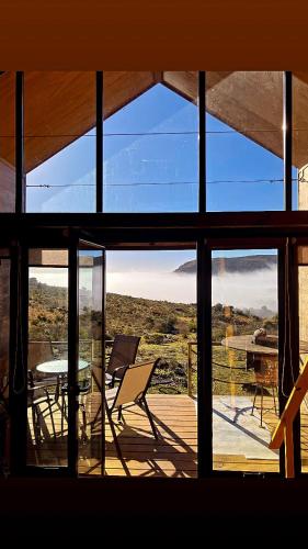 a room with a view of a patio with a table and chairs at Casa Pitoco - Magia en las Sierras in Minas