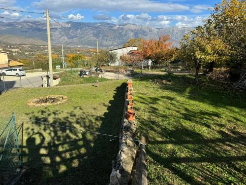 a fence in a field with mountains in the background at Casa Capanna in Bugnara