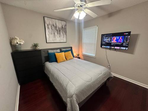 a bedroom with a bed with a ceiling fan at Modern comfort 2BR-2BA Retreat in Concord