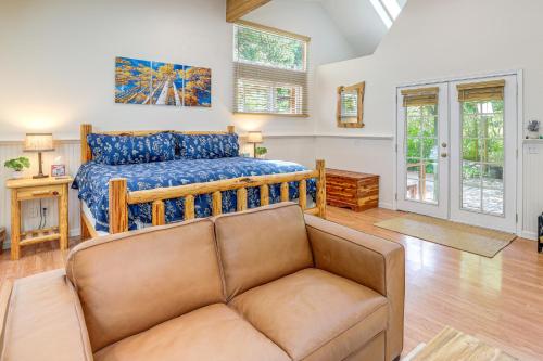 a bedroom with a bed and a couch at Spring-Fed Soaking Tub! Lush Central Oregon Haven in McKenzie Bridge