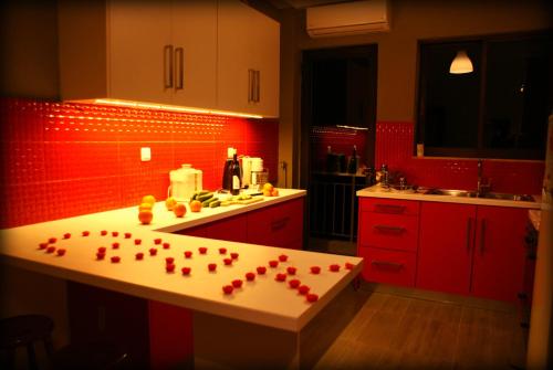 una cucina con pareti rosse e un bancone con cuori di Acropolis View Dream ad Atene