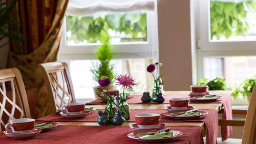 a table with plates and cups and vases on it at Kachelofa GbR in Vaihingen an der Enz