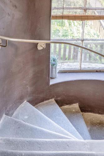 a set of stairs in a room with a window at Vacant Nest Central Location Wifi & Shops in Hawick