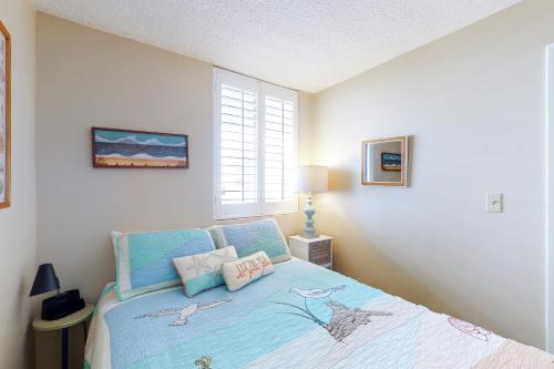 a bedroom with a bed with two pillows on it at Sands Villa 419 in Atlantic Beach