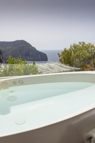 a window with a view of the ocean at Hacienda Na Xamena, Ibiza in Na Xamena