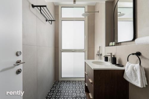 a bathroom with a sink and two windows at Eilat 42-by rently in Eilat