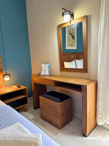 a bedroom with a wooden desk with a mirror at Armenopetra View Gerolimenas in Gerolimenas