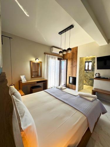 a bedroom with a large white bed in a room at Armenopetra View Gerolimenas in Gerolimenas
