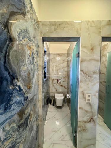 a bathroom with a painting on the wall at Armenopetra View Gerolimenas in Gerolimenas