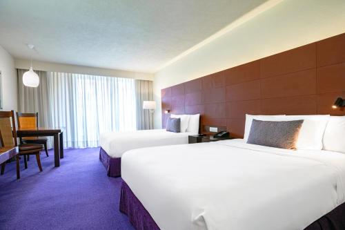 a large hotel room with two beds and a desk at Camino Real Polanco Mexico in Mexico City