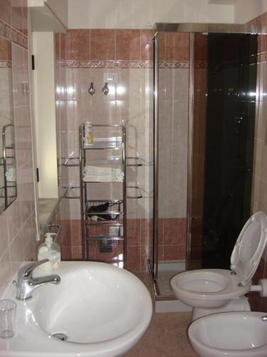 a bathroom with a sink and a toilet and a shower at B&B Emmanuel2 in Reggio Calabria