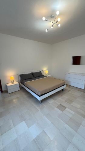 a bedroom with a bed and two tables in a room at Dimora Tra Mare e Montagna in Lanciano