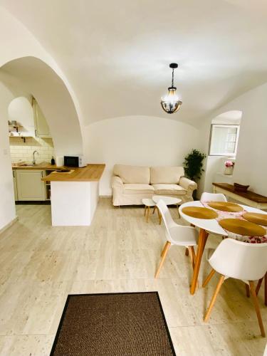 a living room with a table and a couch at Hanna Vendégház-Tállya in Tállya