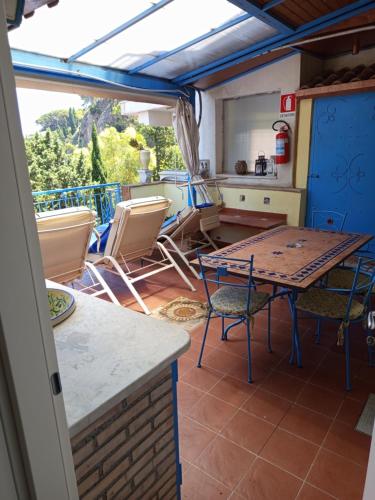 a kitchen and dining room with a table and chairs at ToviMar Apartments in Taormina