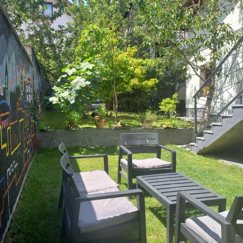 a group of chairs and tables in the grass at APARTMENTS NENSI in Sarajevo