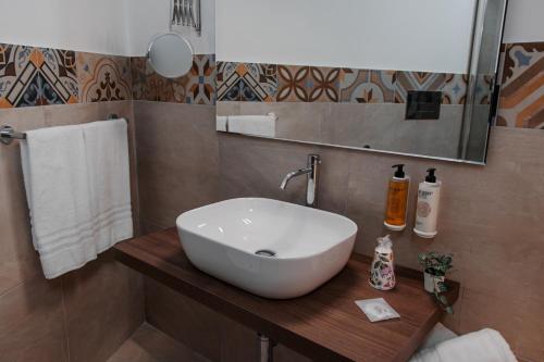 a bathroom with a white sink and a mirror at Vacanze da Beppuccio Scoglitti in Vittoria