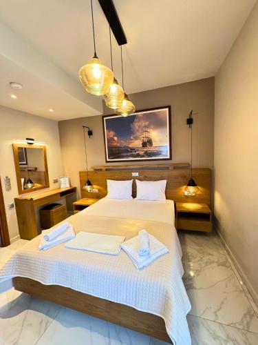 a bedroom with a large bed with two towels on it at Armenopetra View Gerolimenas in Gerolimenas