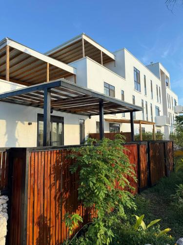 a house with a wooden fence in front of it at 1 BDR Garden Apartment at The Soul, Paje in Paje