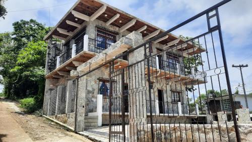 an old building under construction with a fence at Casa de Campo Papalote in Cuetzalán del Progreso