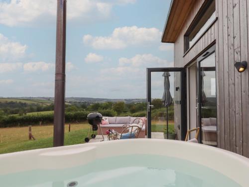 a bath tub in front of a house with a view at The Bickleigh in Tiverton