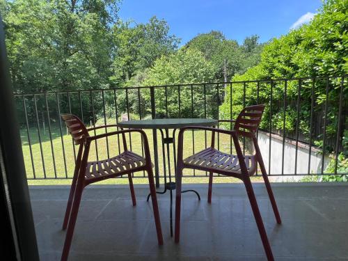 a table and two chairs sitting on a balcony at Cal Cisteller in Santa Pau