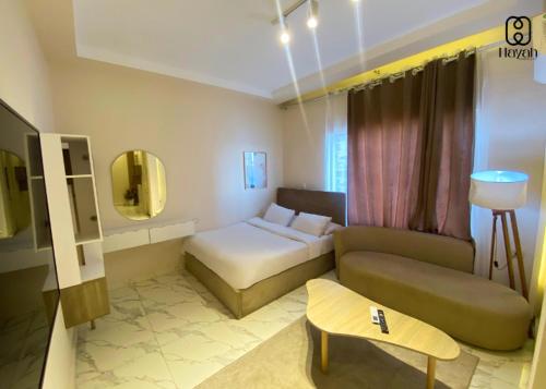 a hotel room with a bed and a couch at Hayah Waterfalls Hotels in Alexandria