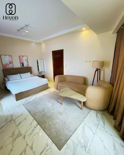 a hotel room with a bed and a couch at Hayah Waterfalls Hotels in Alexandria