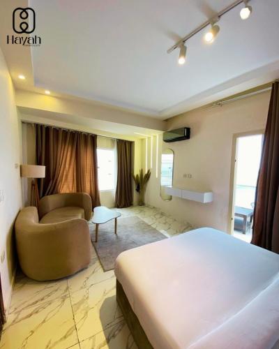 a hotel room with a bed and a couch at Hayah Waterfalls Hotels in Alexandria