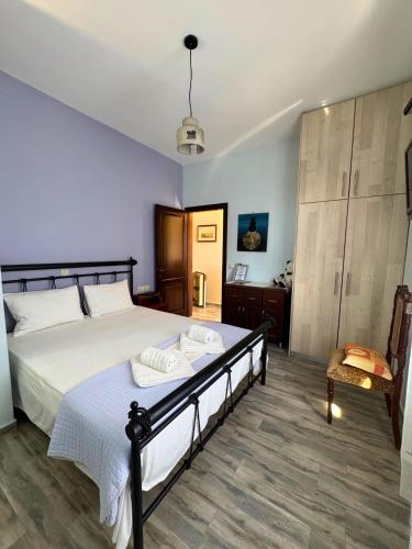 a bedroom with a large bed and a chair at Armenopetra View Gerolimenas in Gerolimenas