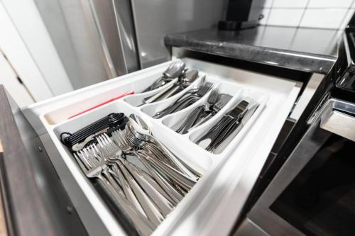 a drawer filled with utensils in a kitchen at Outdoor Sauna Hot Tub Playroom Port Dallhousie in St. Catharines