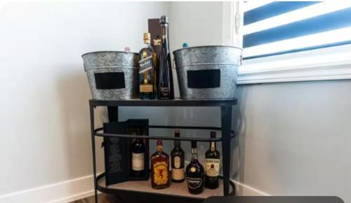 a shelf with bottles and buckets on a wall at Outdoor Sauna Hot Tub Playroom Port Dallhousie in St. Catharines