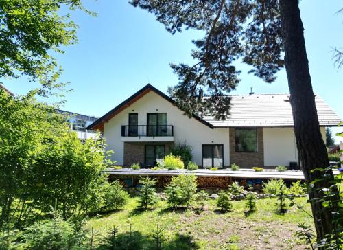 a house with a garden in front of it at Apartmány Runi in Stará Lesná