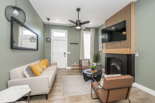 a living room with a couch and a fireplace at The Baymiller Row - For 6 in Cincinnati