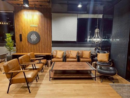 a lobby with a couch and chairs and a table at Black Sheep House Khaoyai by ALPHATEL PARTNER in Pong Talong