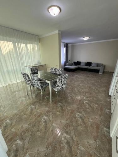 a living room with a table and chairs and a couch at Rare apartment in kojori in Tbilisi City