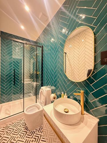 a bathroom with a sink and a glass shower at Pear Tree Inn in Welwyn Garden City