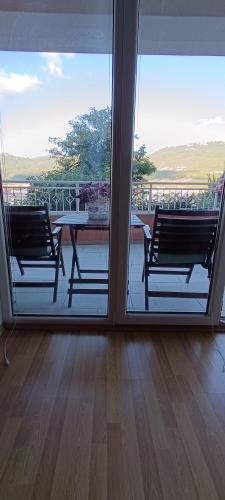 a balcony with two benches and a table on a balcony at Boris & Matej Apartments in Ohrid