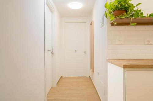 a kitchen with white walls and a wooden floor at NonnaLo' bed and breakfast in Verbicaro