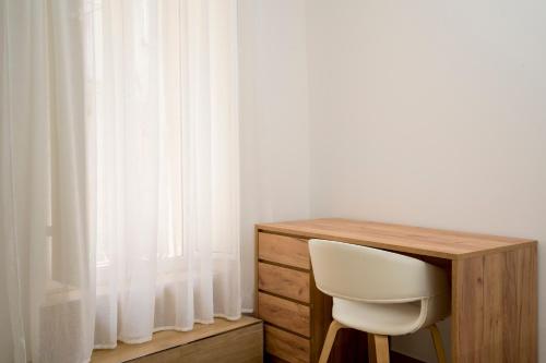 a white chair sitting next to a wooden desk at NonnaLo' bed and breakfast in Verbicaro