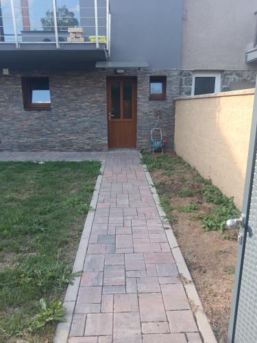 a walkway in front of a house with a door at Apartmán Slapy &Svatojánské proudy in Štěchovice