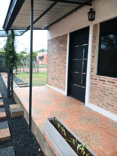 a front door of a house with a porch at La casita de Miguel in Villarrica
