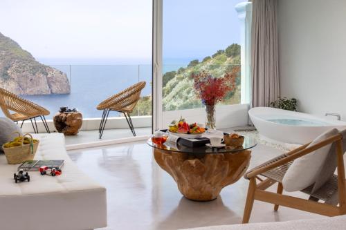 a living room with a view of the ocean at Hacienda Na Xamena, Ibiza in Na Xamena