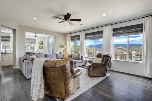 a living room with a couch and chairs and windows at Highpoint Hills Great Views w Games & Fitness in Colorado Springs