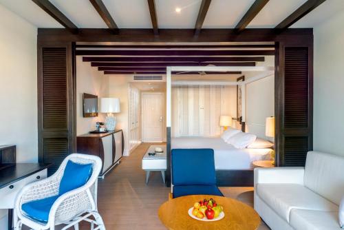a hotel room with a bed and a living room at Ocean Riviera Paradise All Inclusive in Playa del Carmen