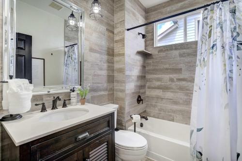a bathroom with a sink and a toilet and a tub at Highpoint Hills Great Views w Games & Fitness in Colorado Springs