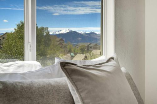 a window with a view of a snowy mountain at Highpoint Hills Great Views w Games & Fitness in Colorado Springs