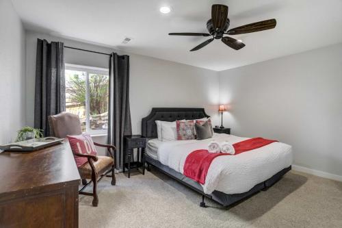 a bedroom with a bed with a ceiling fan and a desk at Highpoint Hills Great Views w Games & Fitness in Colorado Springs