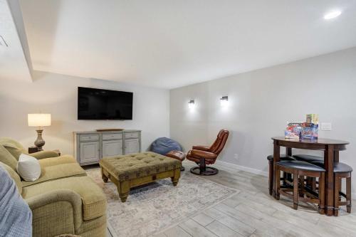 a living room with a couch and a table at Highpoint Hills Great Views w Games & Fitness in Colorado Springs
