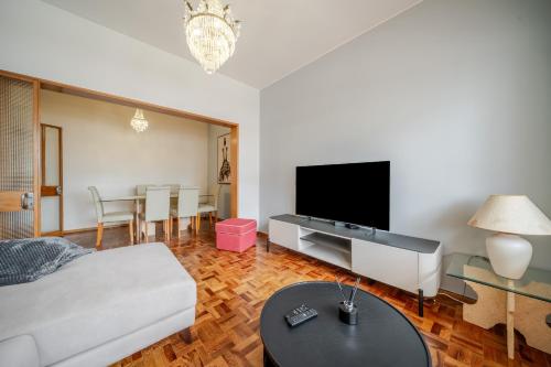 a living room with a bed and a flat screen tv at Dream House by MGM Stays in Loulé